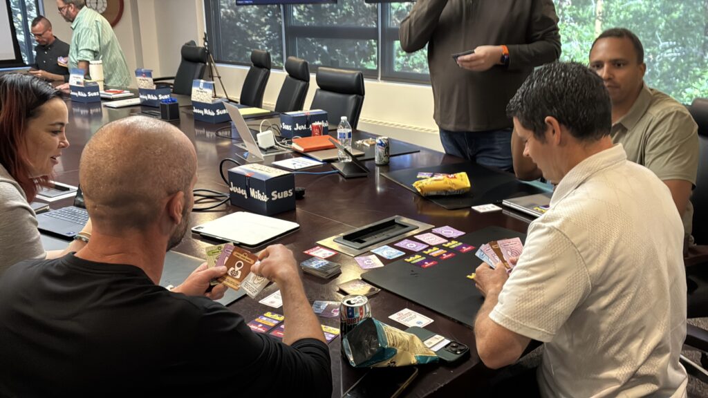 A corporate team playing Hack Attack: Defense around a conference table